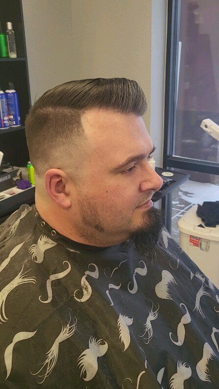 Finished mid-fade with a styled beard
